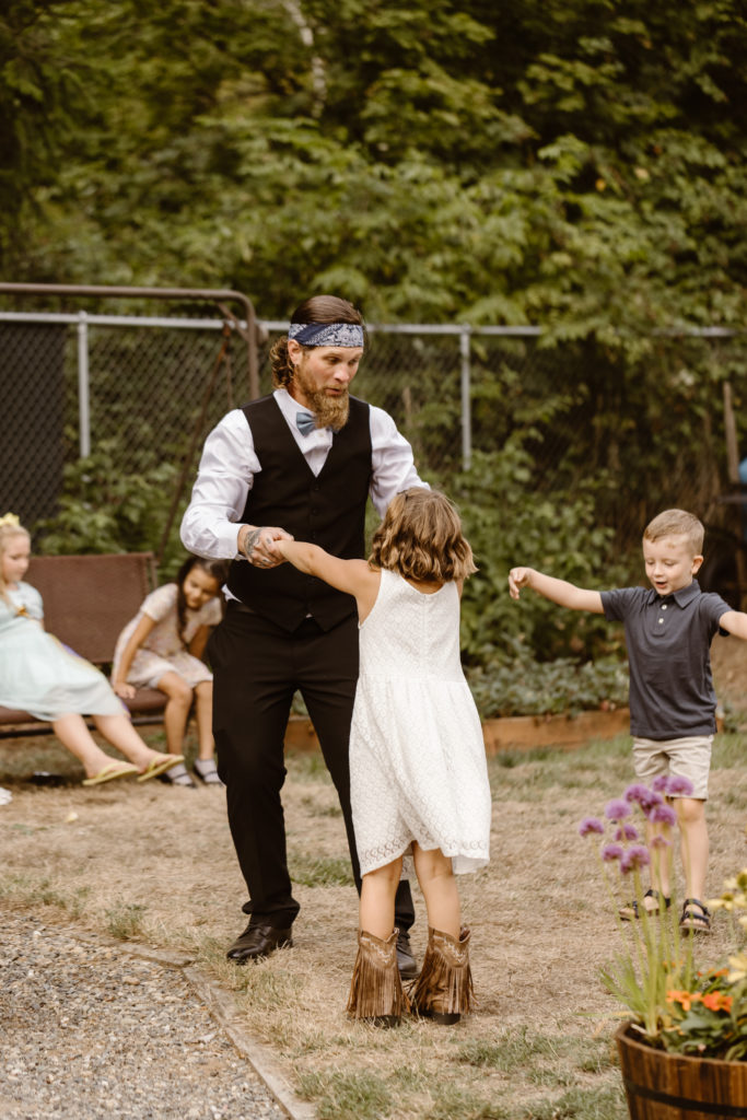 Father dancing with young daughter at his wedding