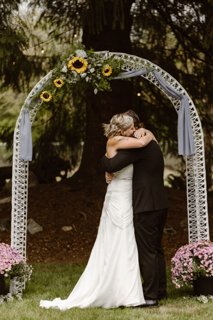 Intimate moment for bride and groom after their first kiss at their wedding ceremony