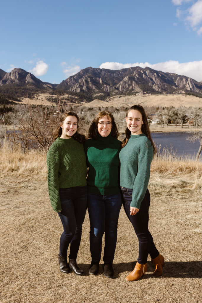 Mom and daughters with the Flatirons in the background