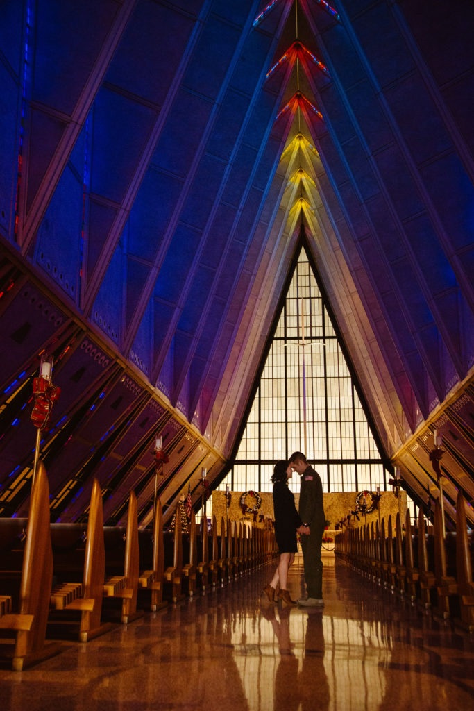 Man in Air Force uniform in the United States Air Force Academy Cadet Chapel with his fiancé