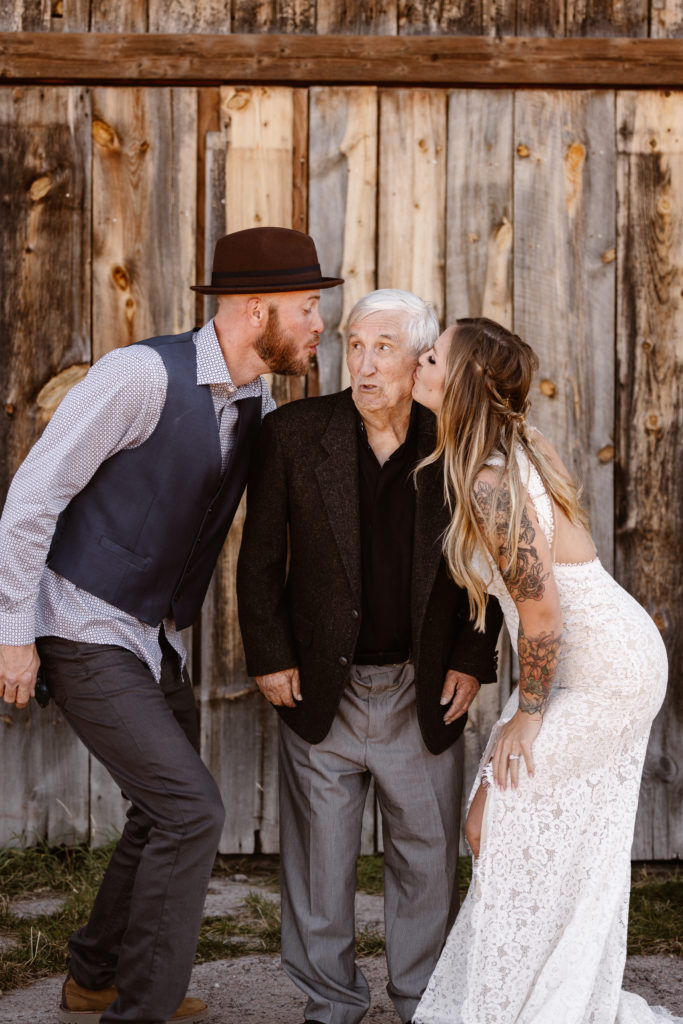 Bride and groom giving grandpa a kiss on the cheek