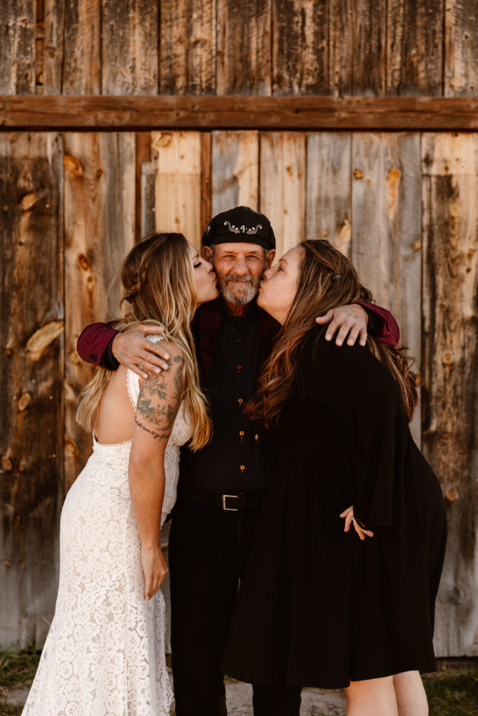 Bride and her sister giving dad a kiss on the cheek