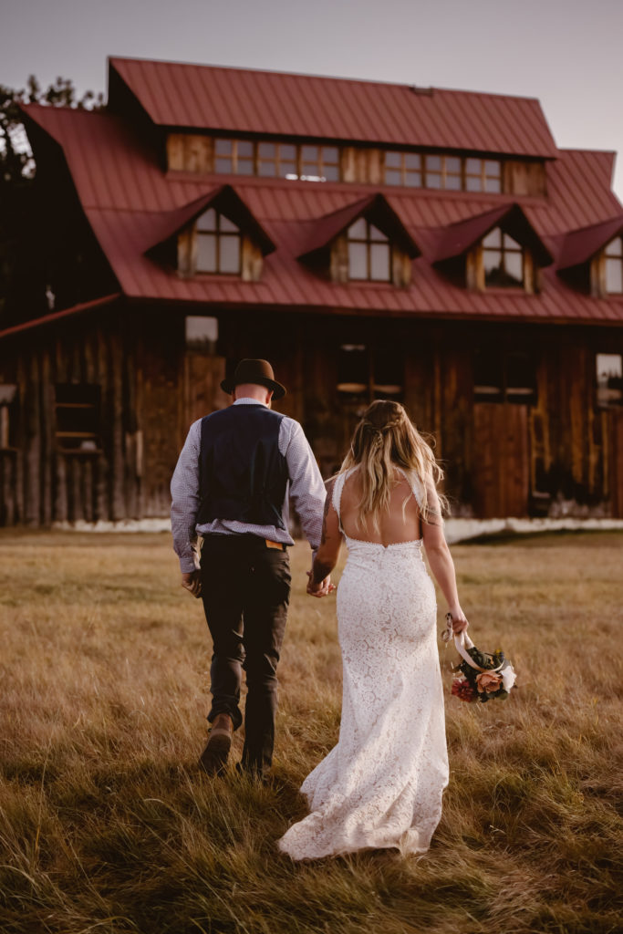 Groom and bride holding hands walking away