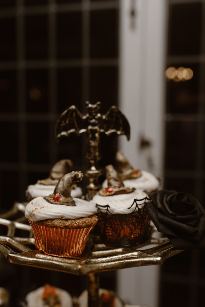 Wedding cupcakes with witches hats on them.