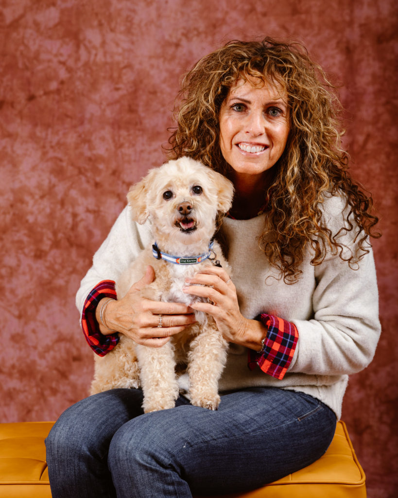 Woman with her dog in a Christmas portrait taken by Simply Cassandra