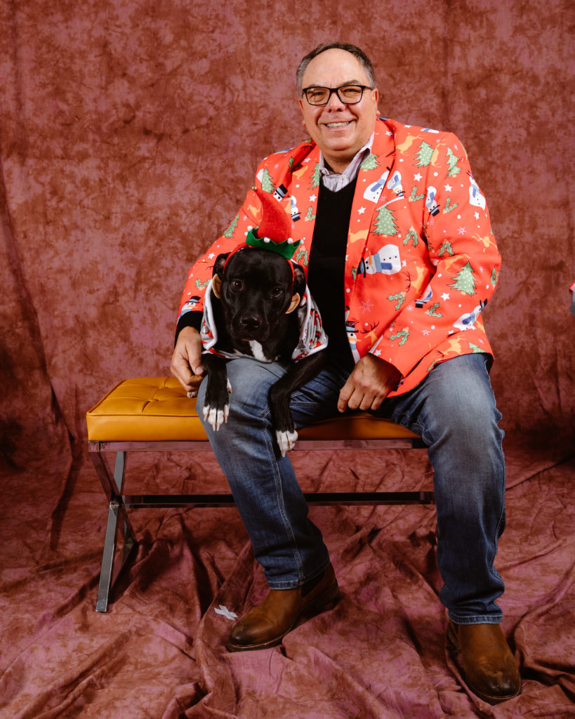 Man with his dog in a Christmas portrait taken by Simply Cassandra