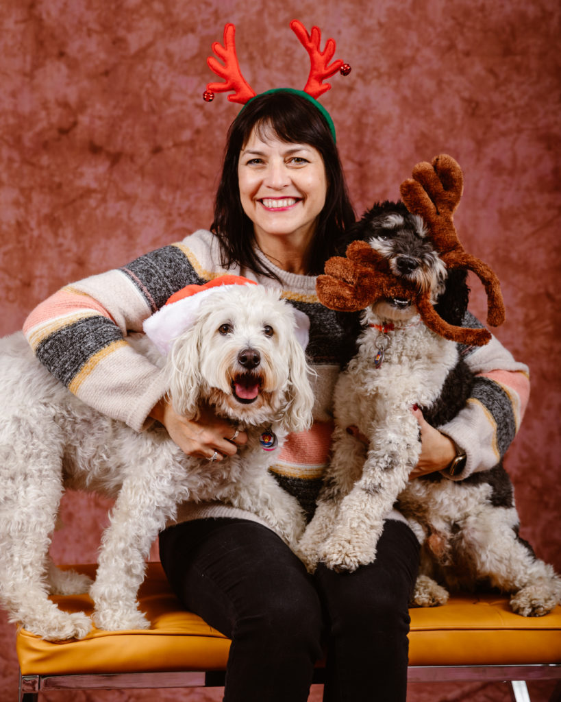 Woman with her dogs in a Christmas portrait taken by Simply Cassandra
