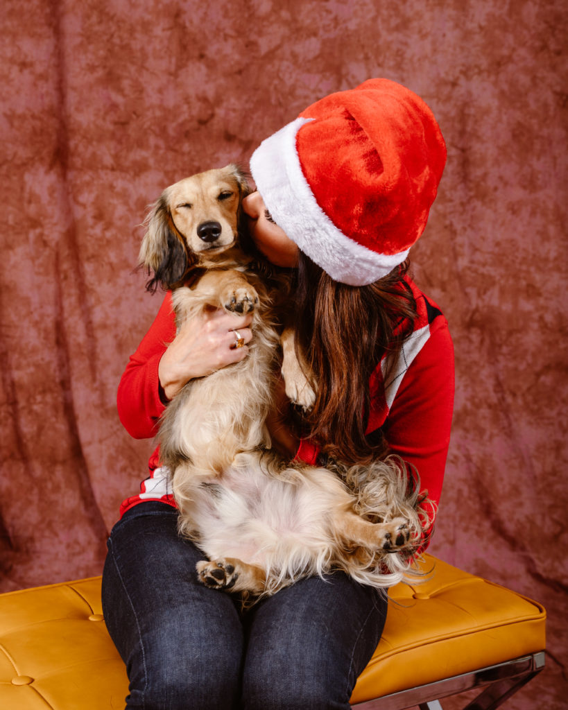 Woman with her dog in a Christmas portrait taken by Simply Cassandra