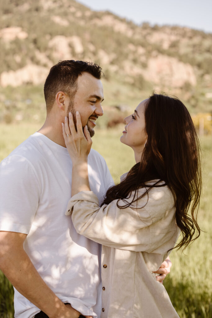 Woman looking into her fiancé's eyes caressing his cheek