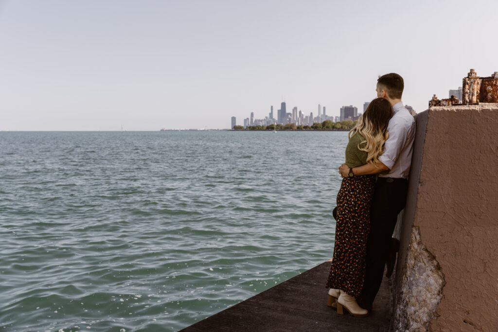 Couple embracing each other looking out over the water