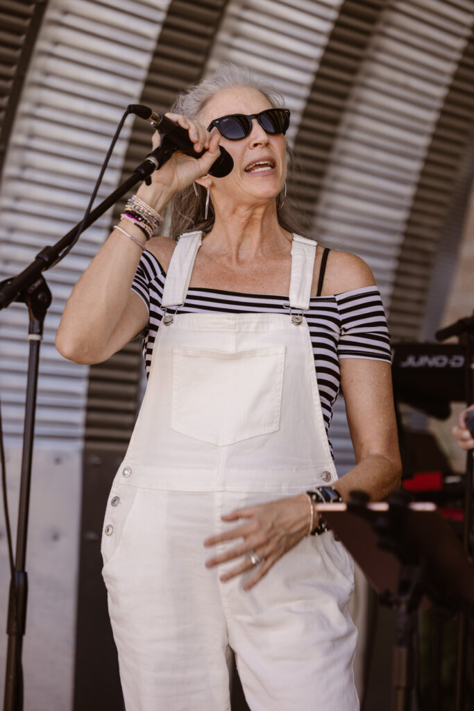 Woman singing into a microphone