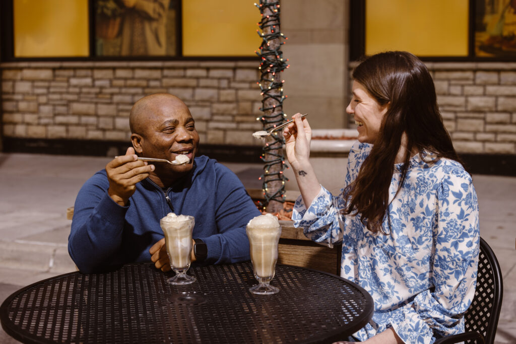 Couple eating root beer floats at an outside table
