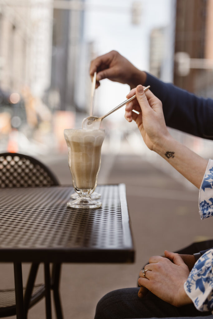 Couple scooping a spoon full of root beer floats at an outside table