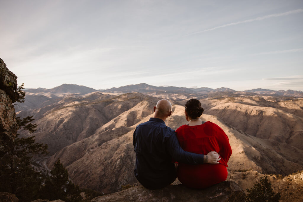 Couple looking at the Rocky Mountain range from a mountain top