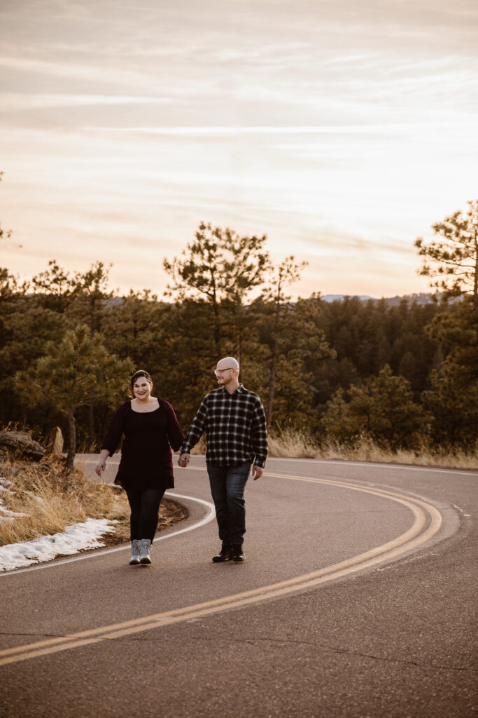 Couple walking down a mountain road holding hands