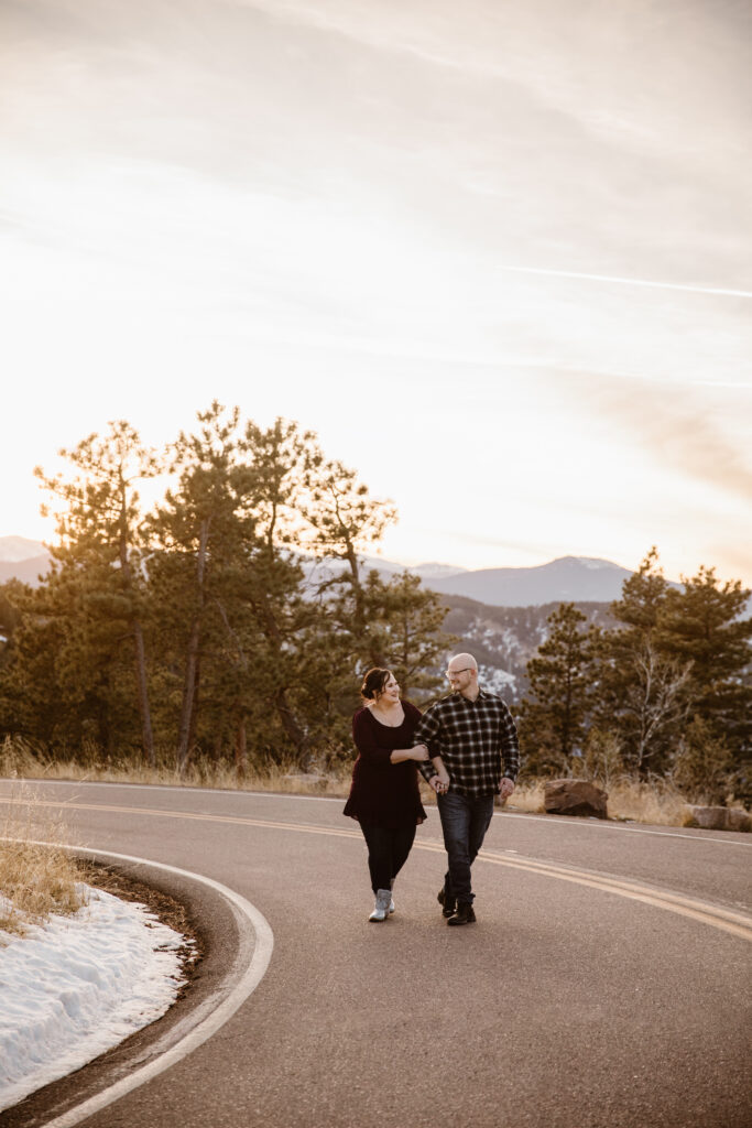 Couple walking down a mountain road arm in arm