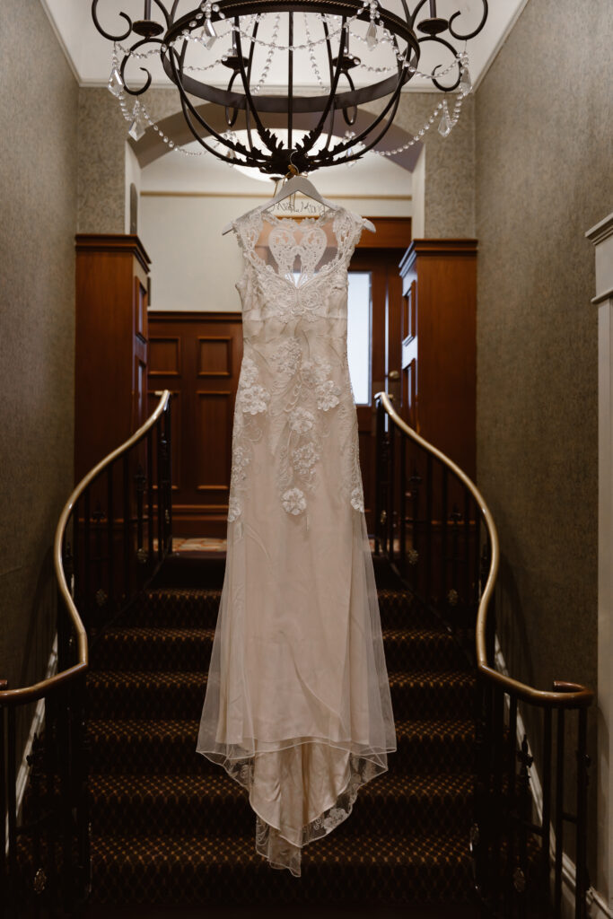 Wedding dress hanging from a chandelier