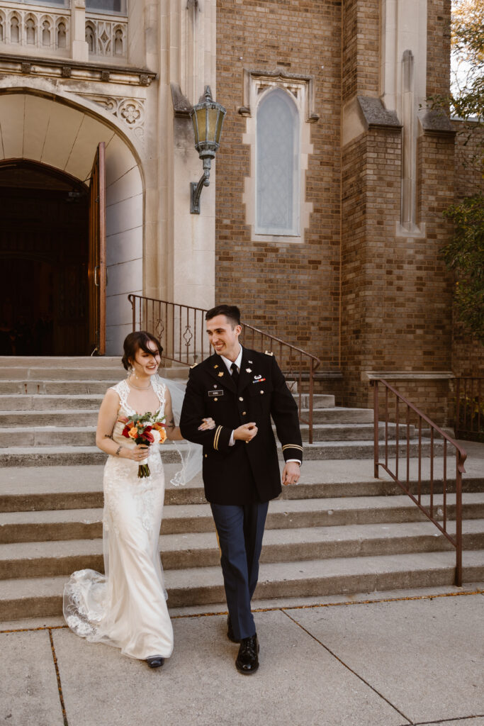 Bride and groom walking outside of their church after their wedding ceremony