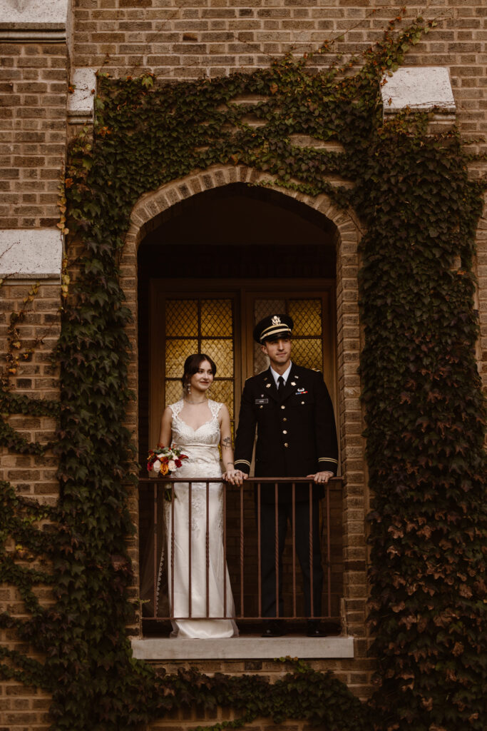 Bride and groom portrait, framed in a brick arch