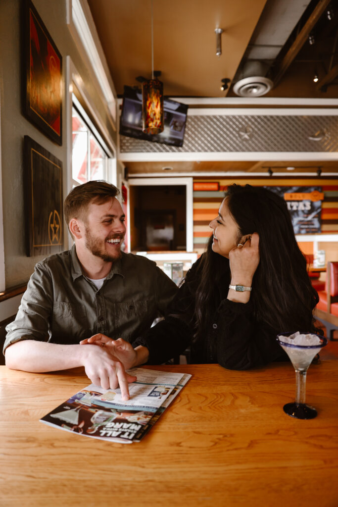 Engaged couple at a Chili's talking over a menu
