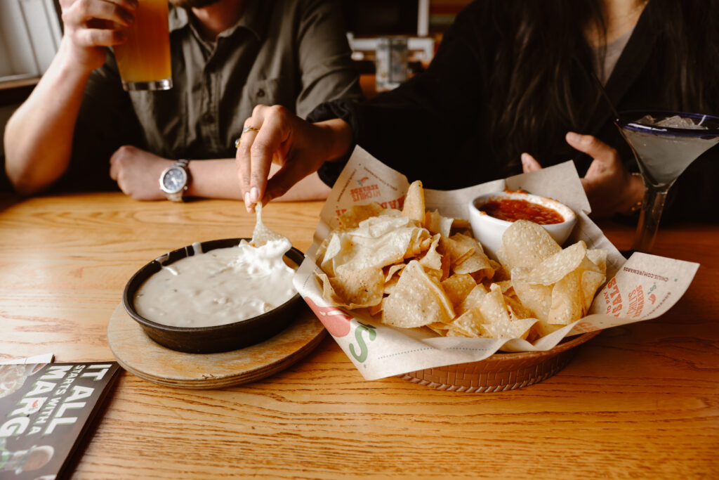 Engaged couple sharing chips and queso at Chili's