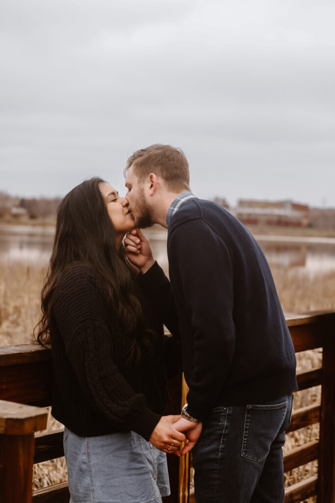 Couple kissing on a dock