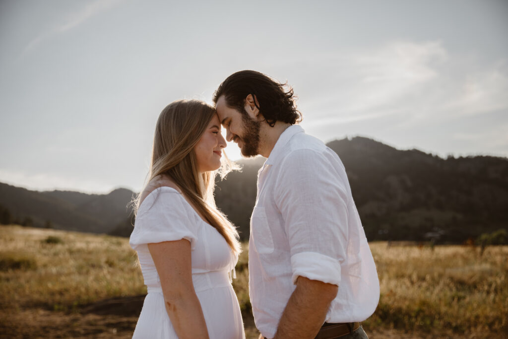 Couple sharing an intimate moment with foreheads touching during their Chautauqua Park engagement session in Boulder, Colorado.