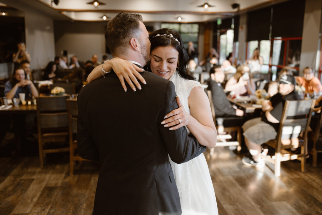 Bride and groom sharing their first dance during wedding reception at Walnut Creek Golf Preserve in Westminster Colorado captured by Colorado wedding photographer.