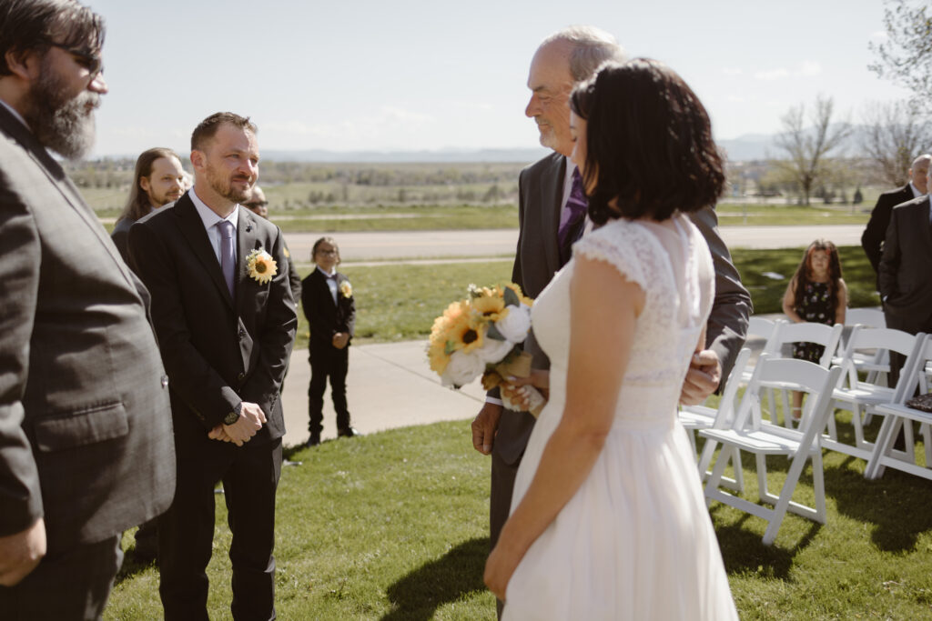 Father of the bride handing his daughter, the bride, to the groom during the ceremony