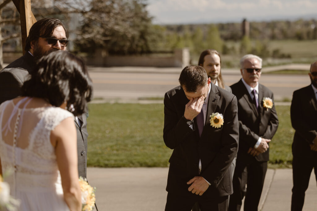 Groom overwhelmed with emotion during wedding ceremony