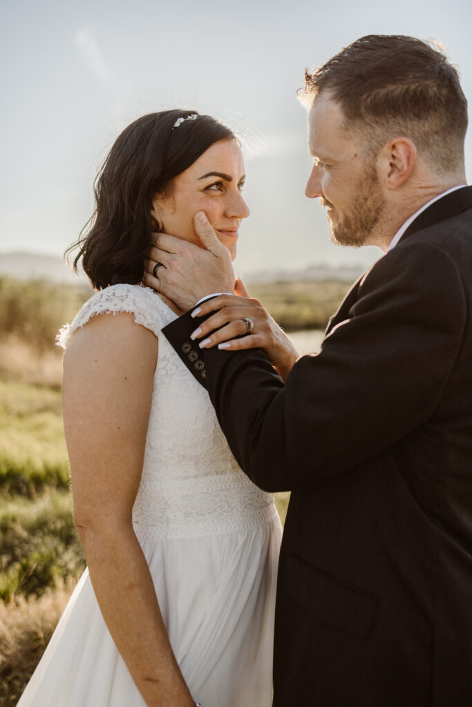 Bride and groom sharing an intimate moment during golden hour portraits at Walnut Creek Golf Preserve wedding in Westminster Colorado by Colorado wedding photographer.
