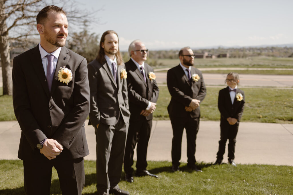 Groom and groom's men standing at the ceremony spot waiting for the bride